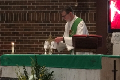 Deacon Mark Keeley, OFS assists at mass at Saint Brigid parish