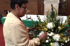 Gerald Allen, OFS arranges flowers for a weekend mass.